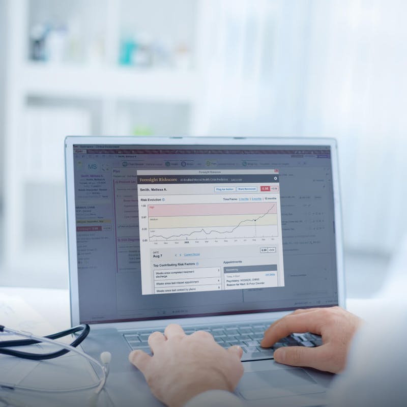 Doctor typing on a laptop