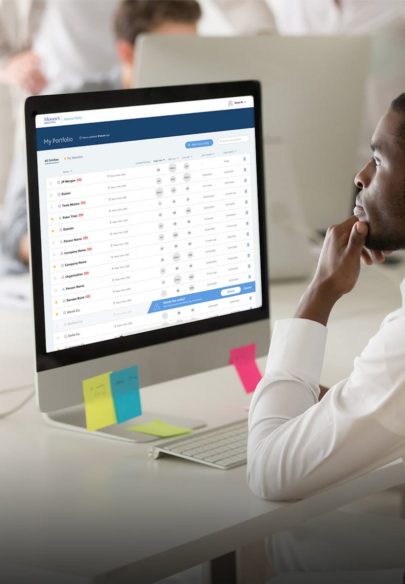 Man looking at a Computer with the Moody's site 