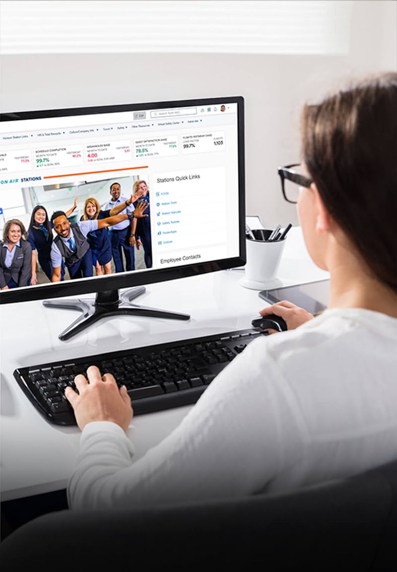 Woman viewing Alaska Airlines intranet on a computer screen