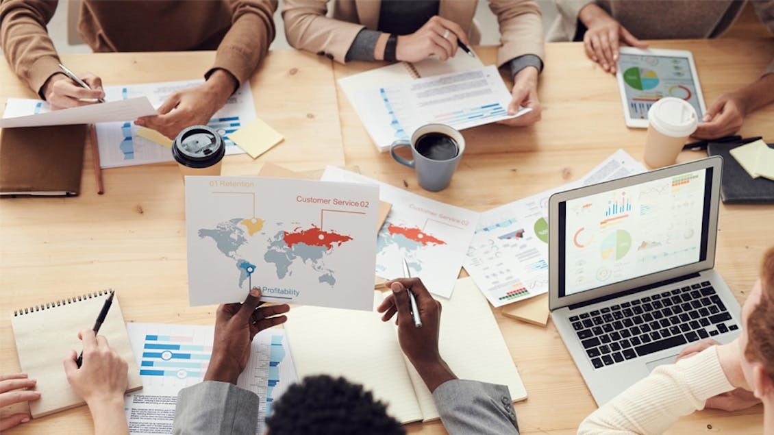 A group of people working and sharing graphs