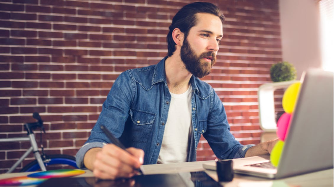 A man working with a designers pad