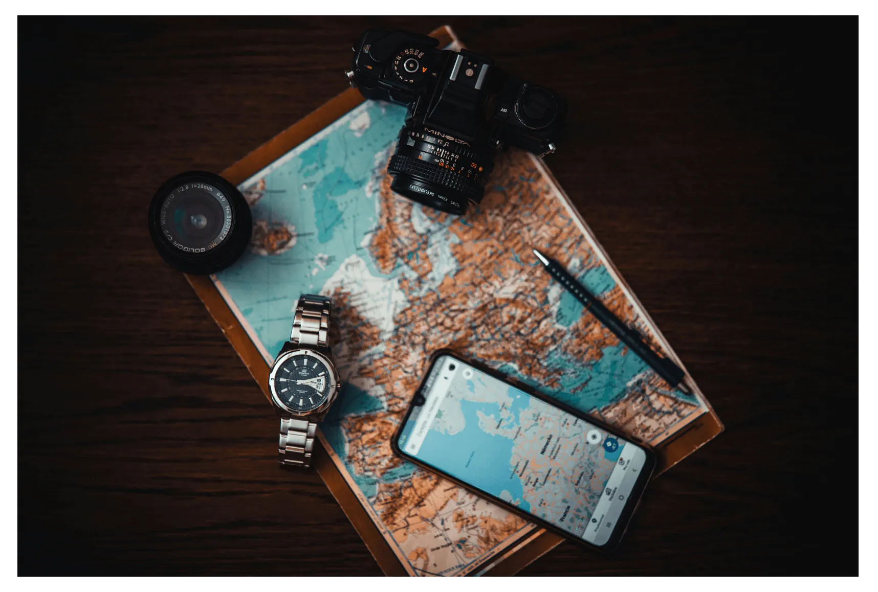 Mockup of a travel app with travel accessories (map, camera, watch, compass)