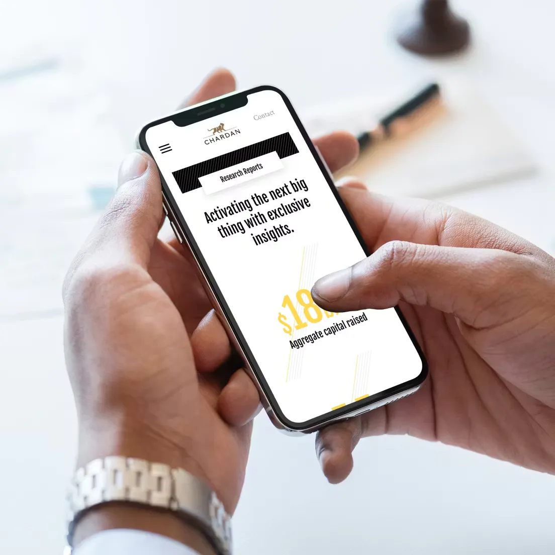 a man with his phone looking at the Chardan Site