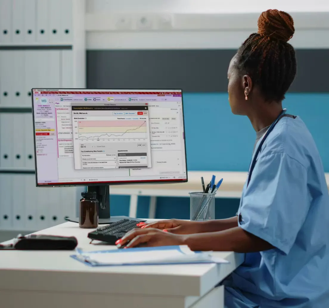 Healthcare worker sitting at a desk with a computer