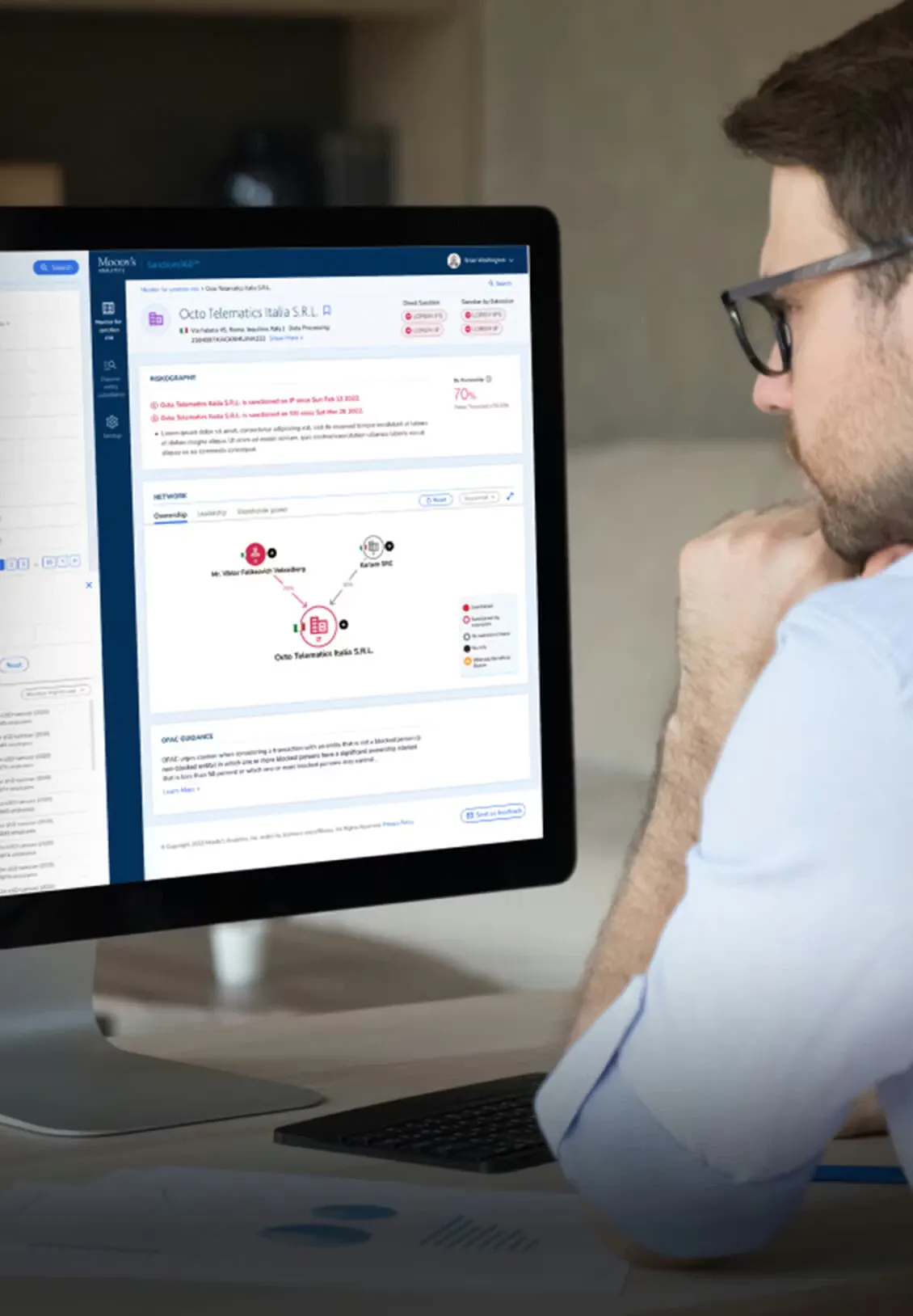 Man looking at the Moody's interface on a computer screen