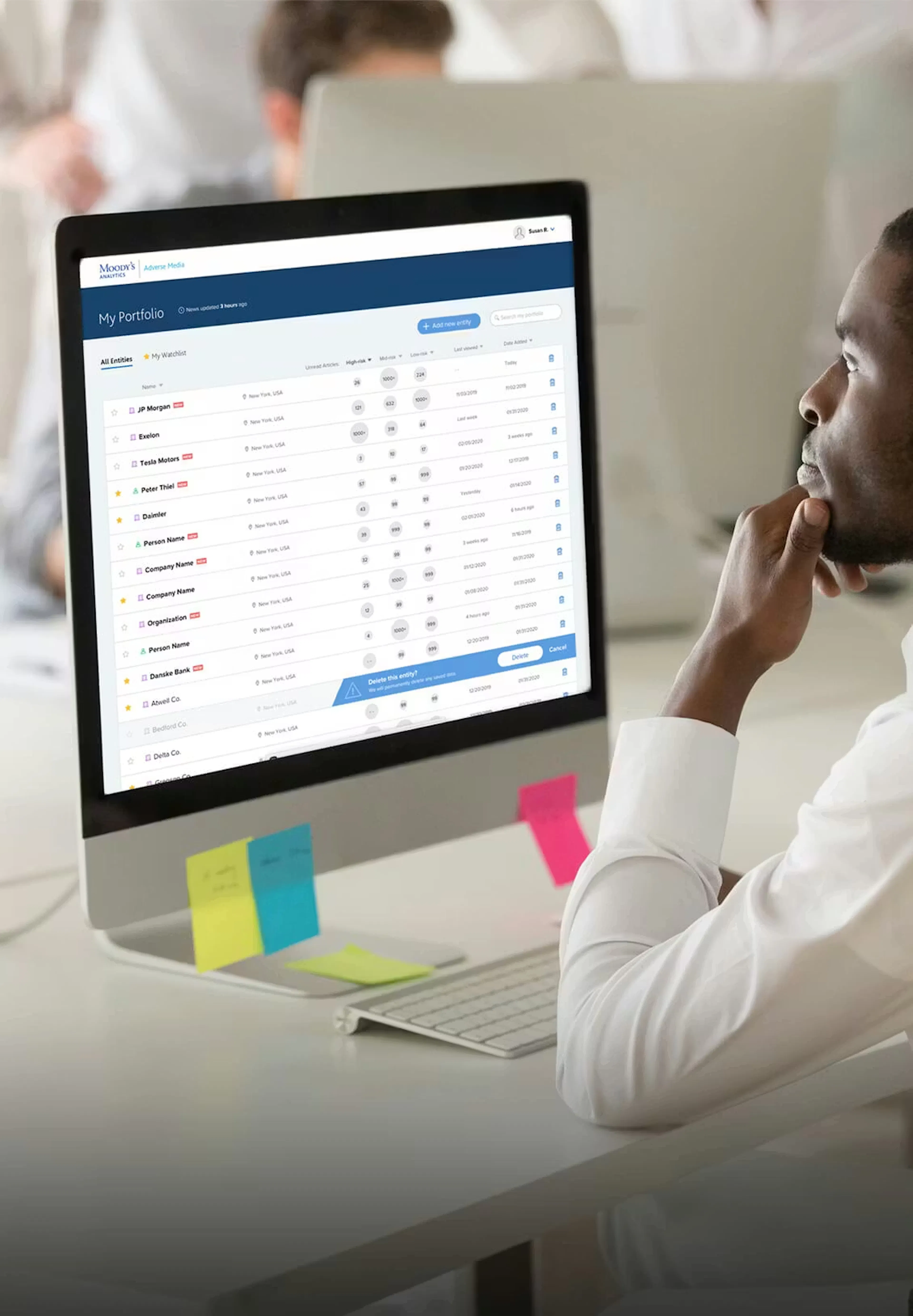 Man looking at a Computer with the Moody's site 