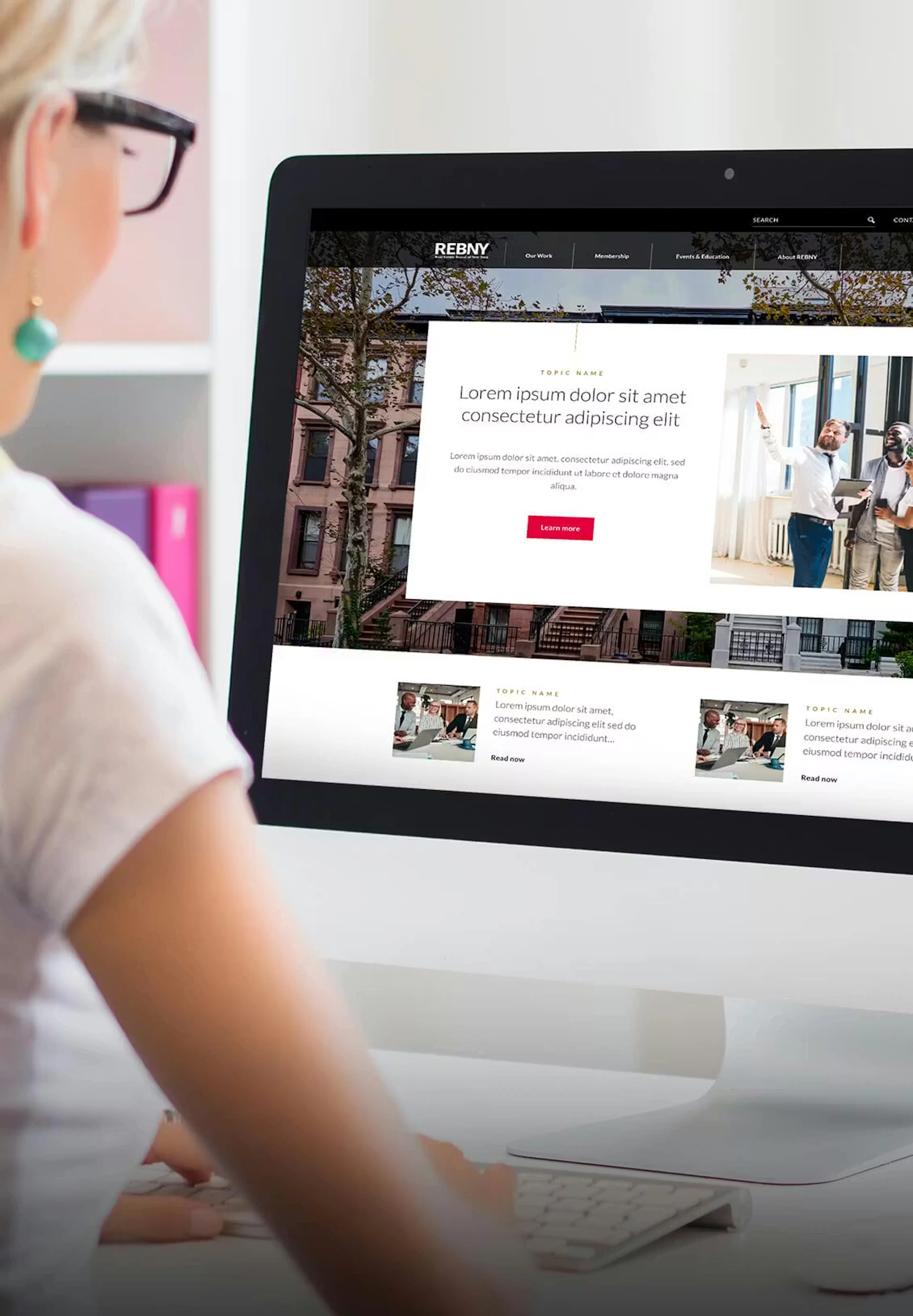 Woman looking at REBNY website on computer screen