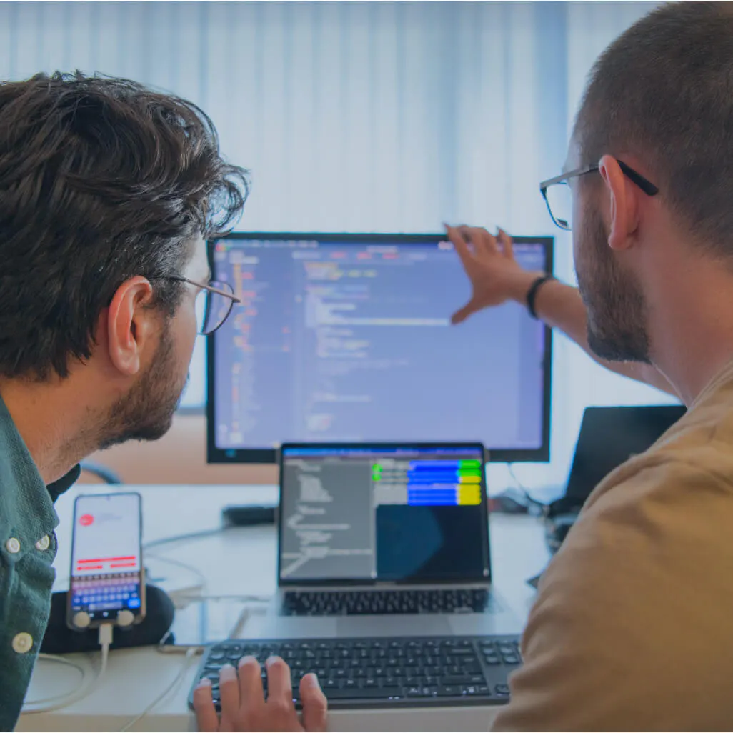 Two employees working on a screen
