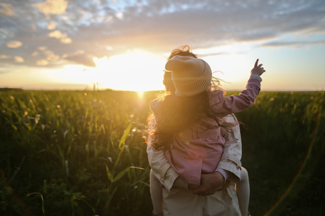 woman and child in sunny field