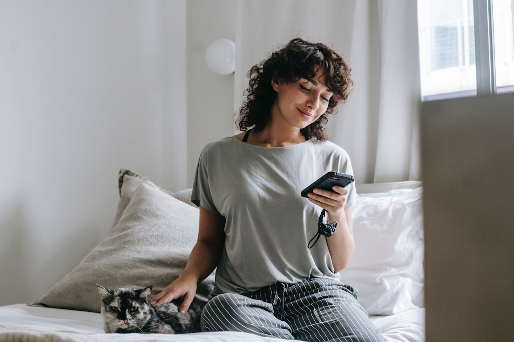 girl on a bed with her phone