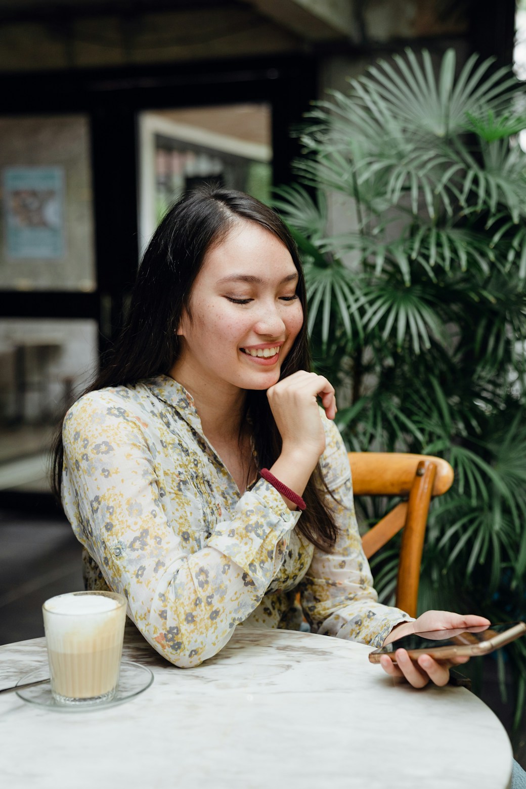 woman smiling at phone