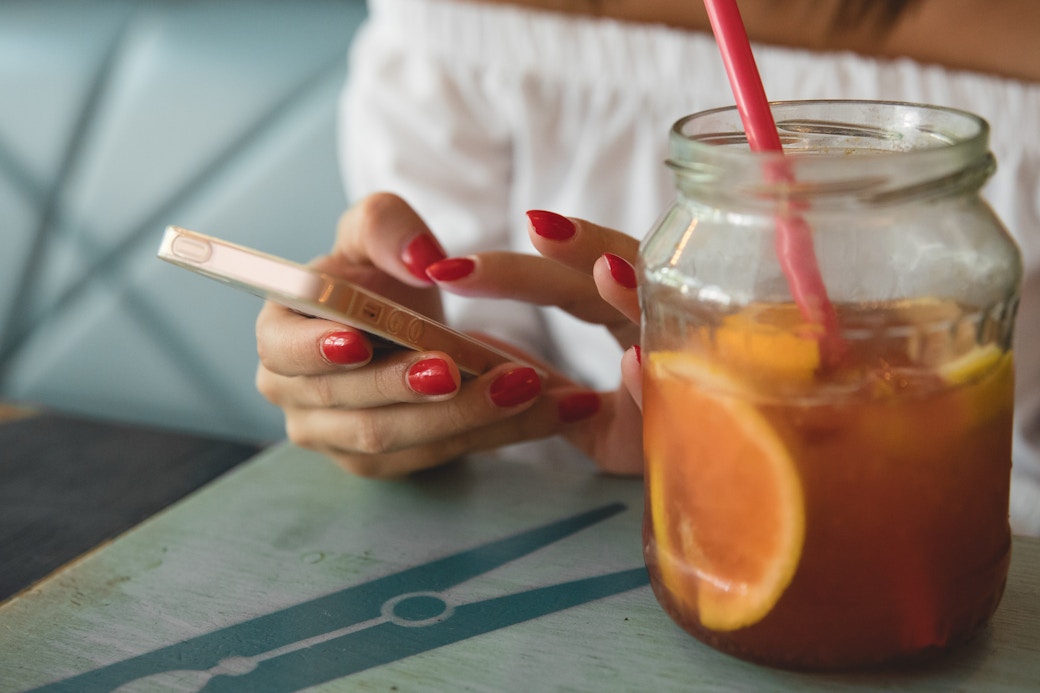 red nails using phone