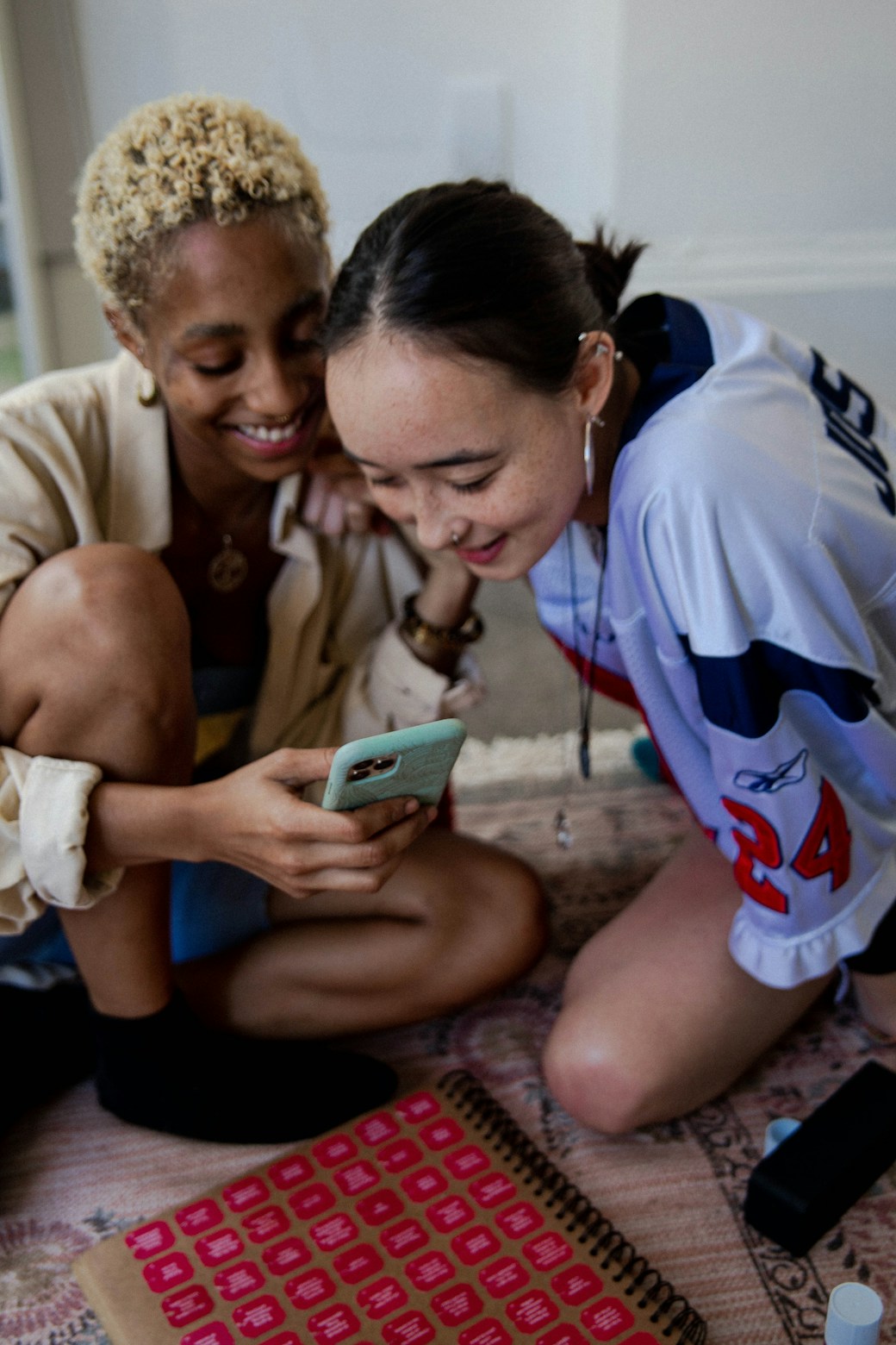 two women smiling at phone