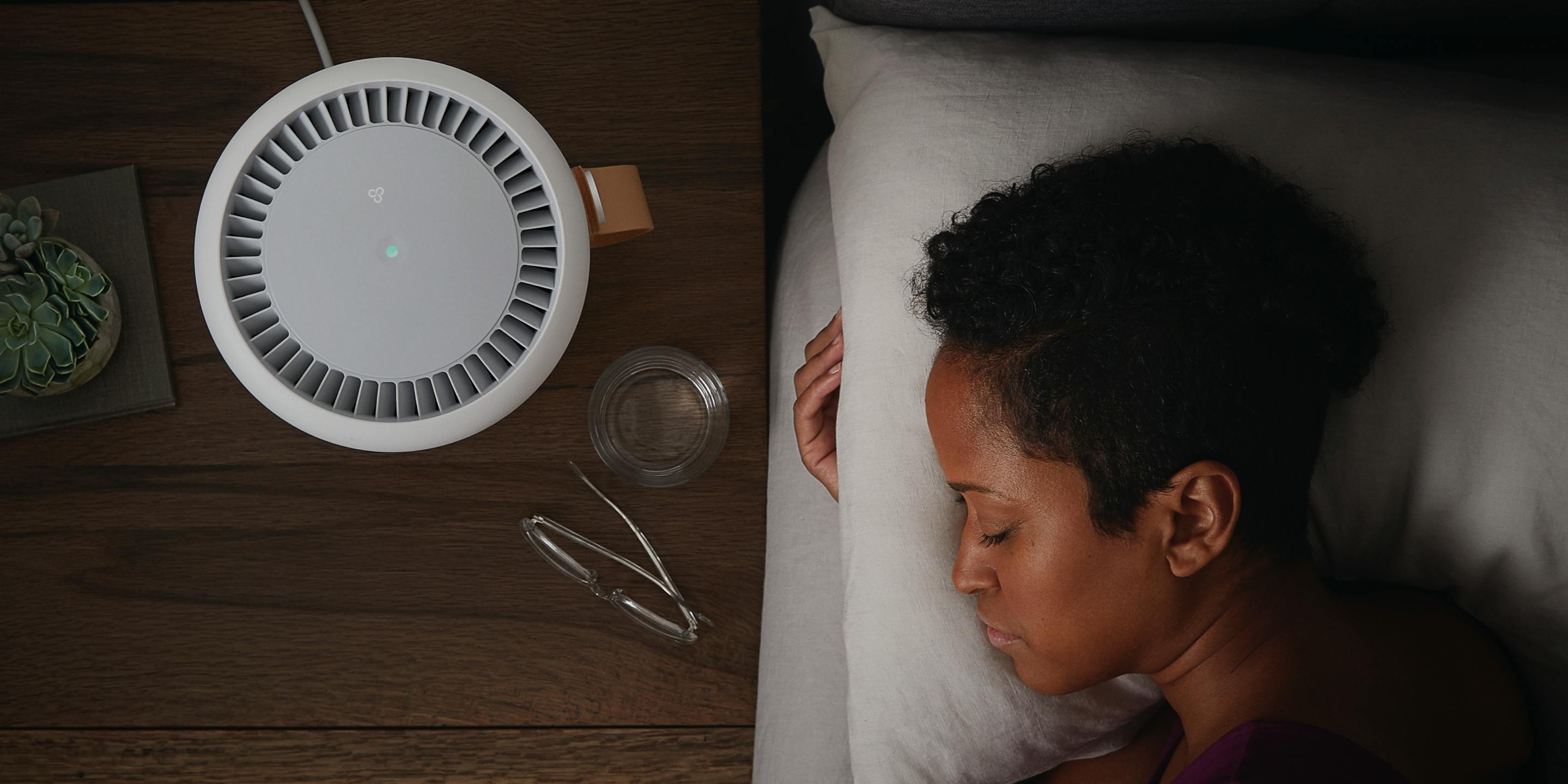 Woman sleeping next to an air purifier | Molekule