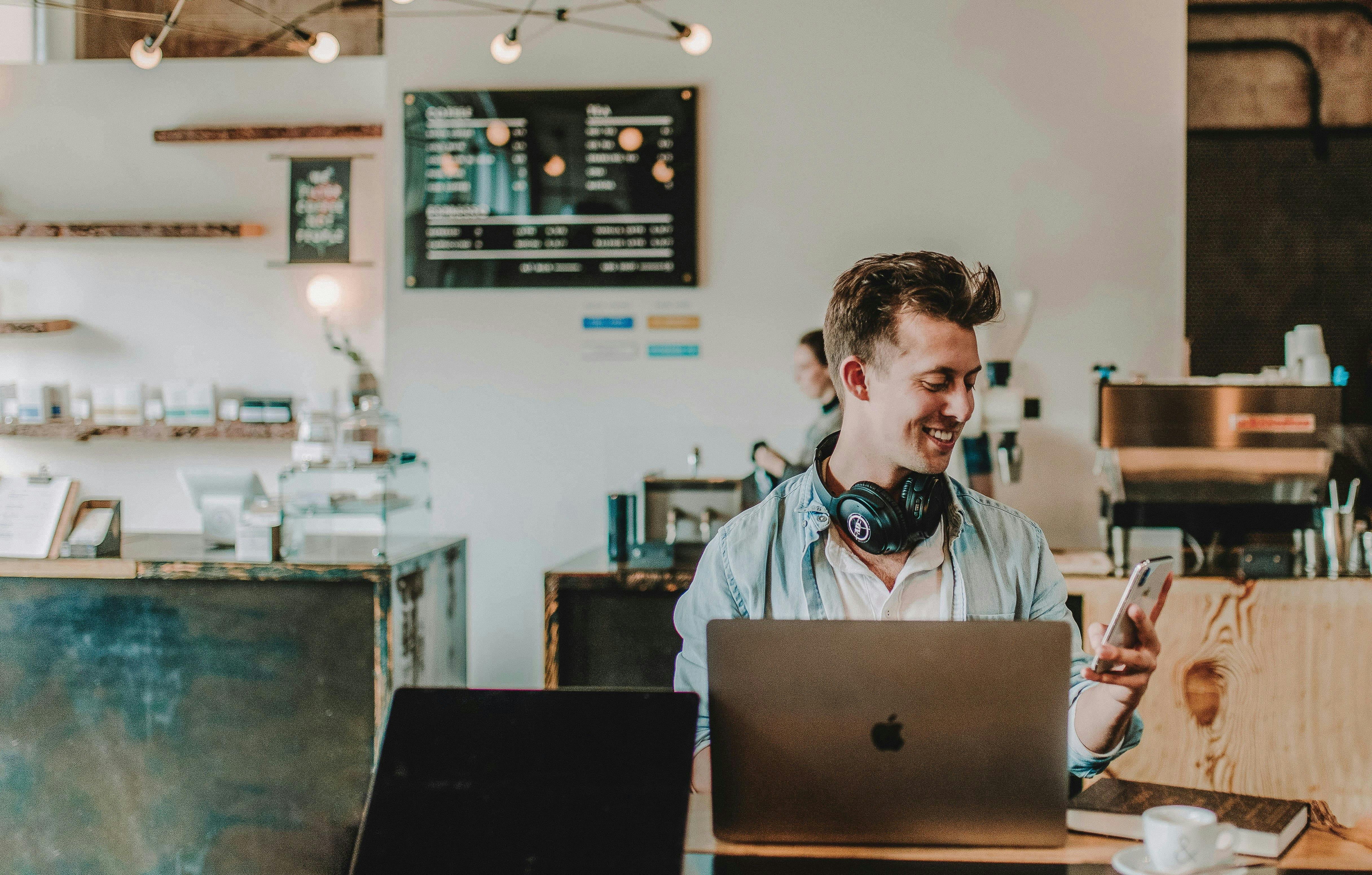small retailer with a smartphone and a computer for payment