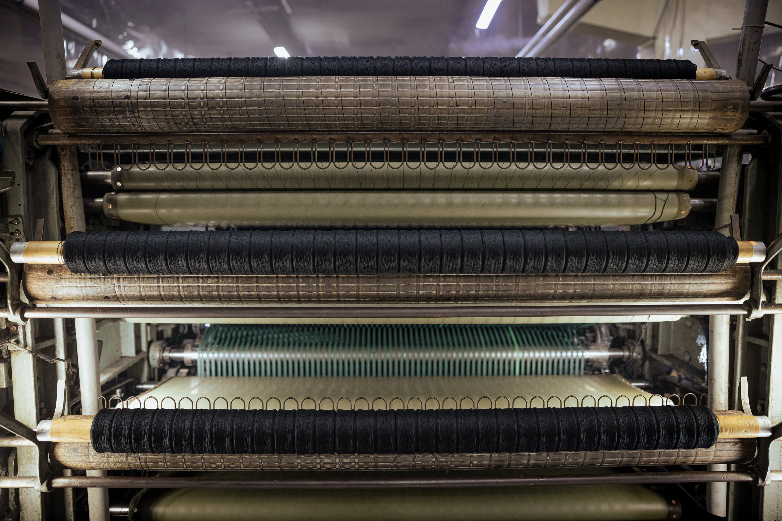 Wide view of yarn-handling machinery.