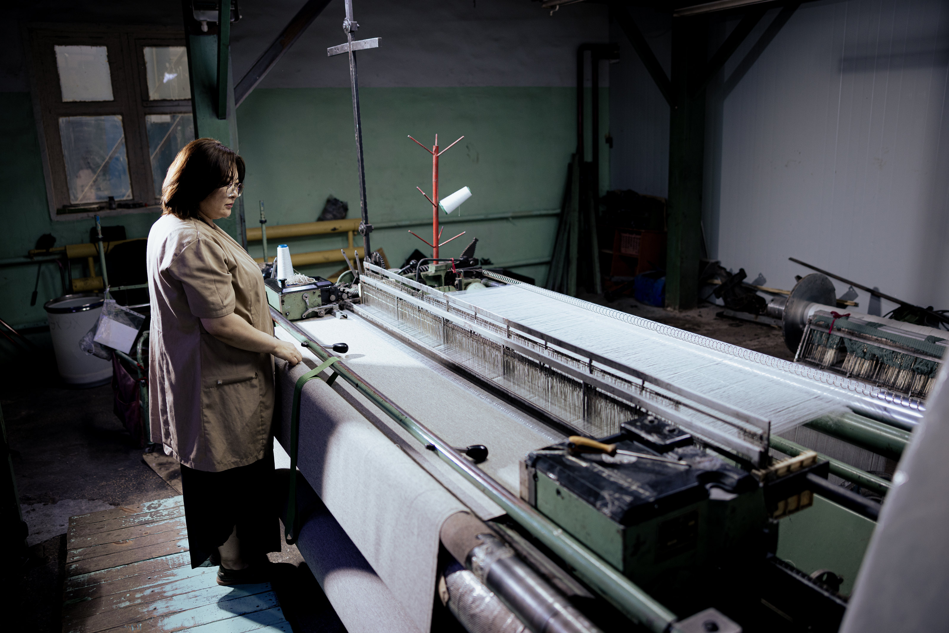 An employee at a weaving loom.