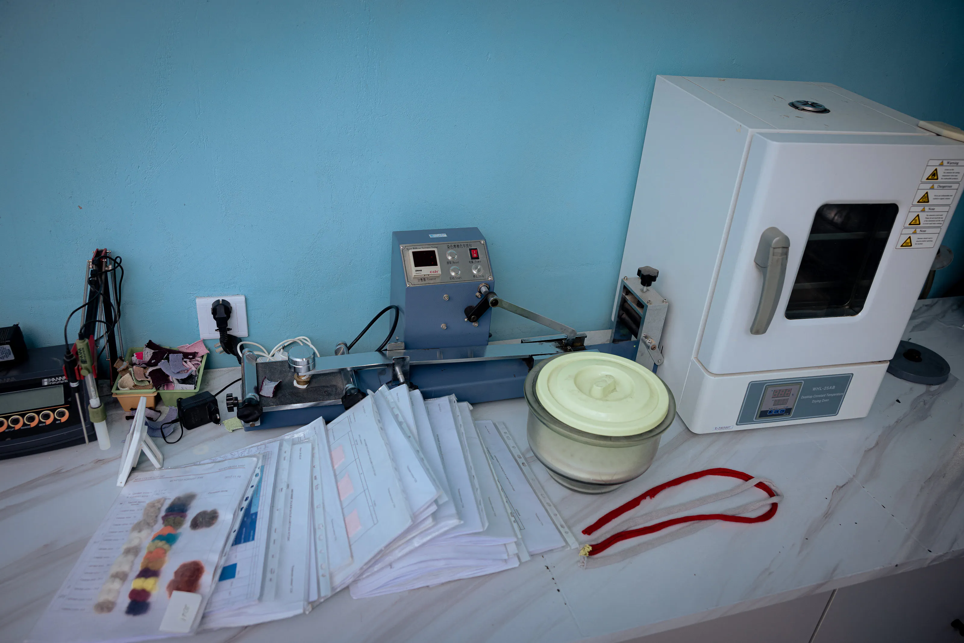 Benchtop instruments, textile samples and colour cards.