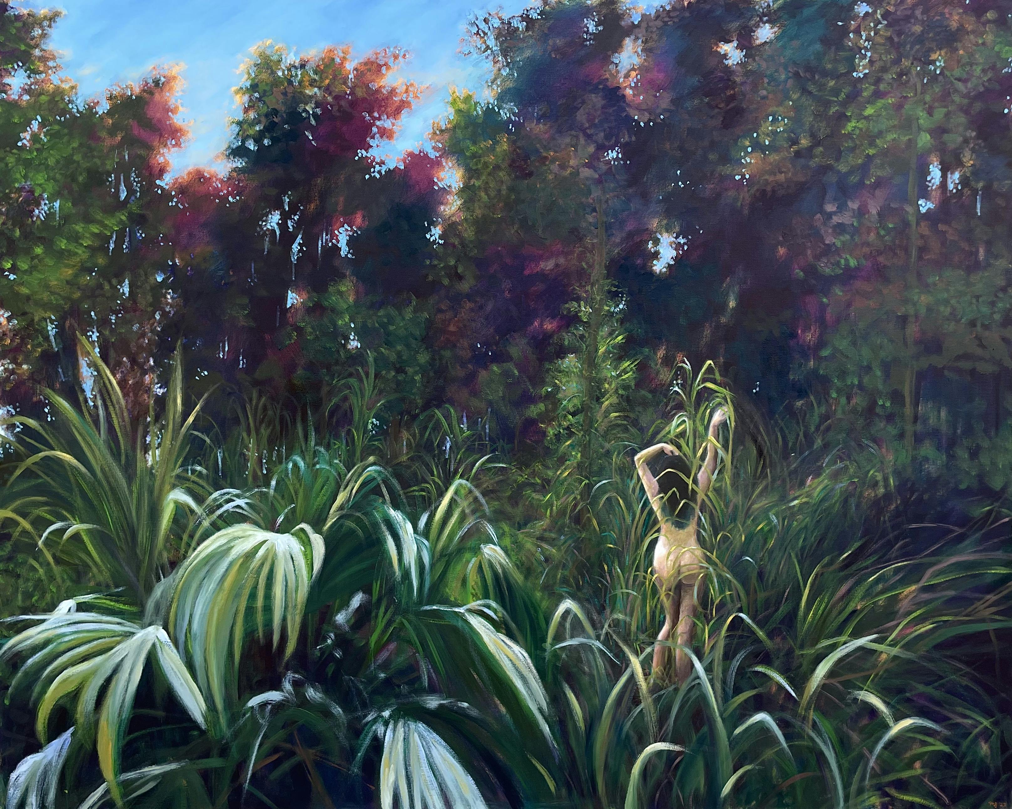 Naked woman with arms extending basking in forest sunlight