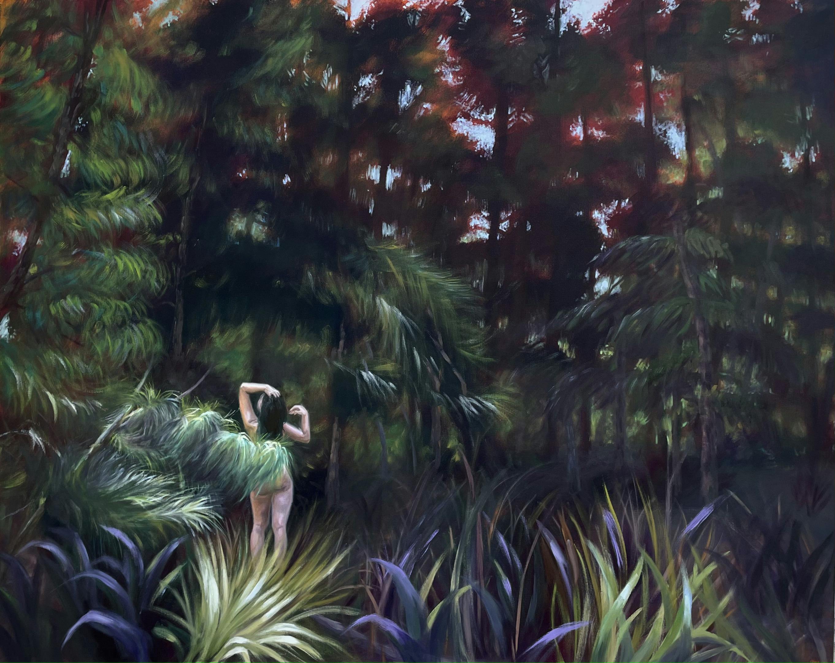 woman covered by foliage with arms extended upwards as if showering in south florida forest