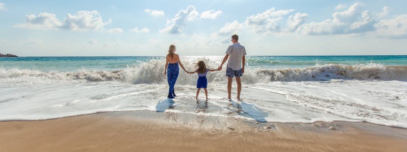 best travel insurance for babies Family on a beach
