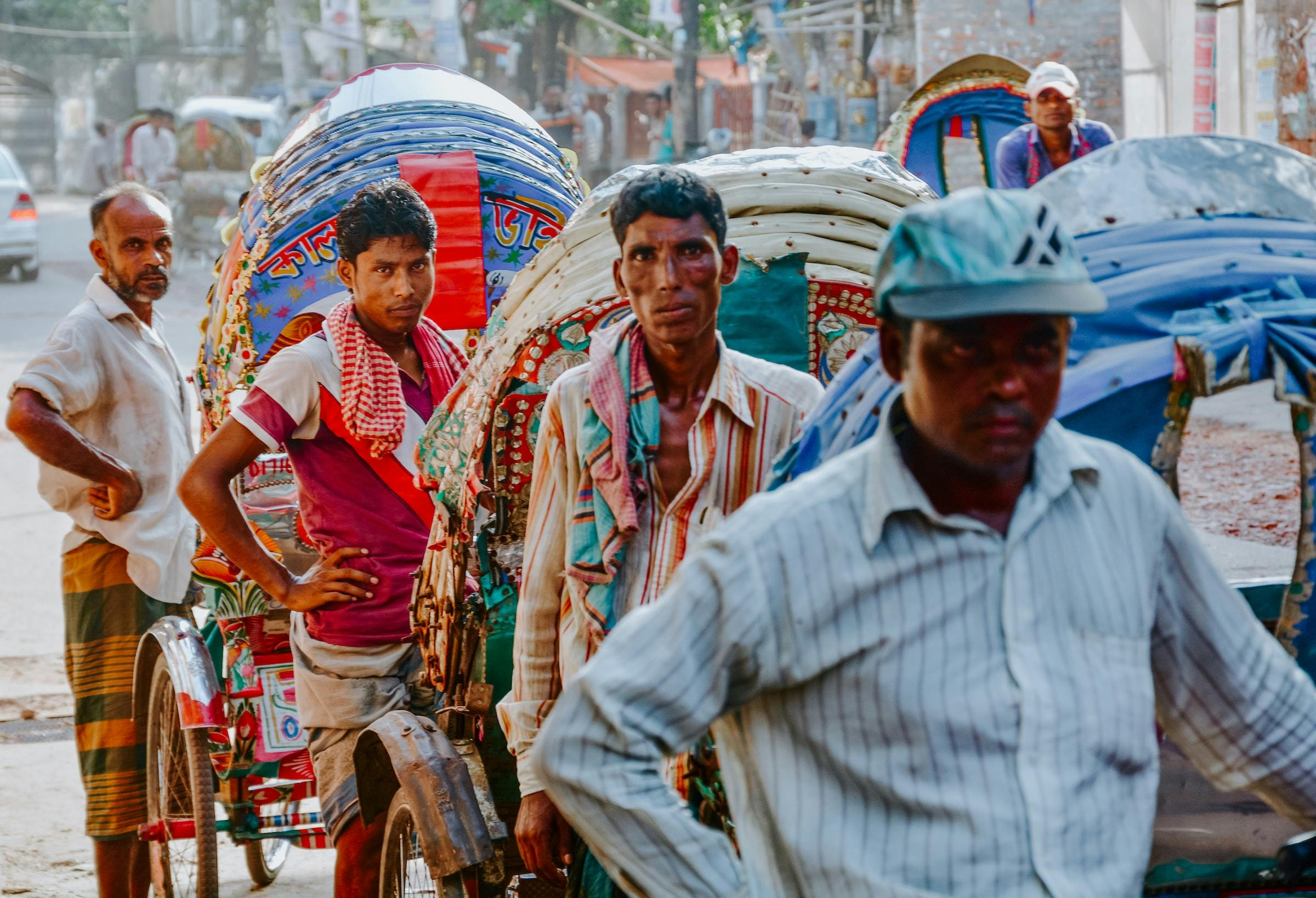 A group of hardworking trishaw operators waiting for customers in Dhaka, Bangladesh. 