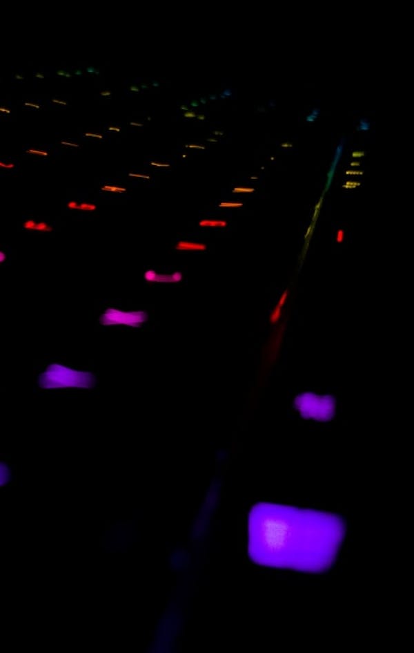 Dark keyboard lit with rainbow lights