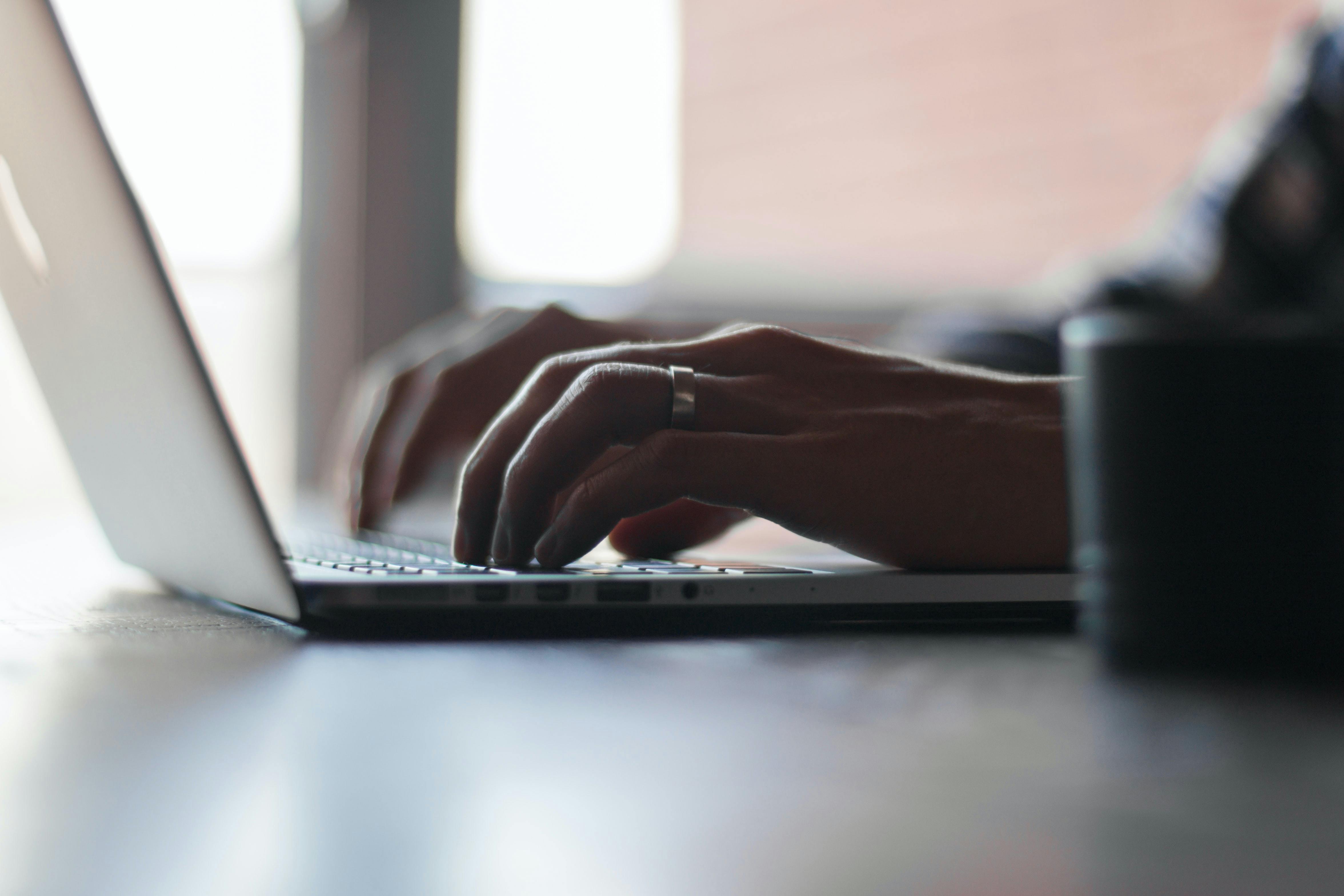 Person typing at their computer
