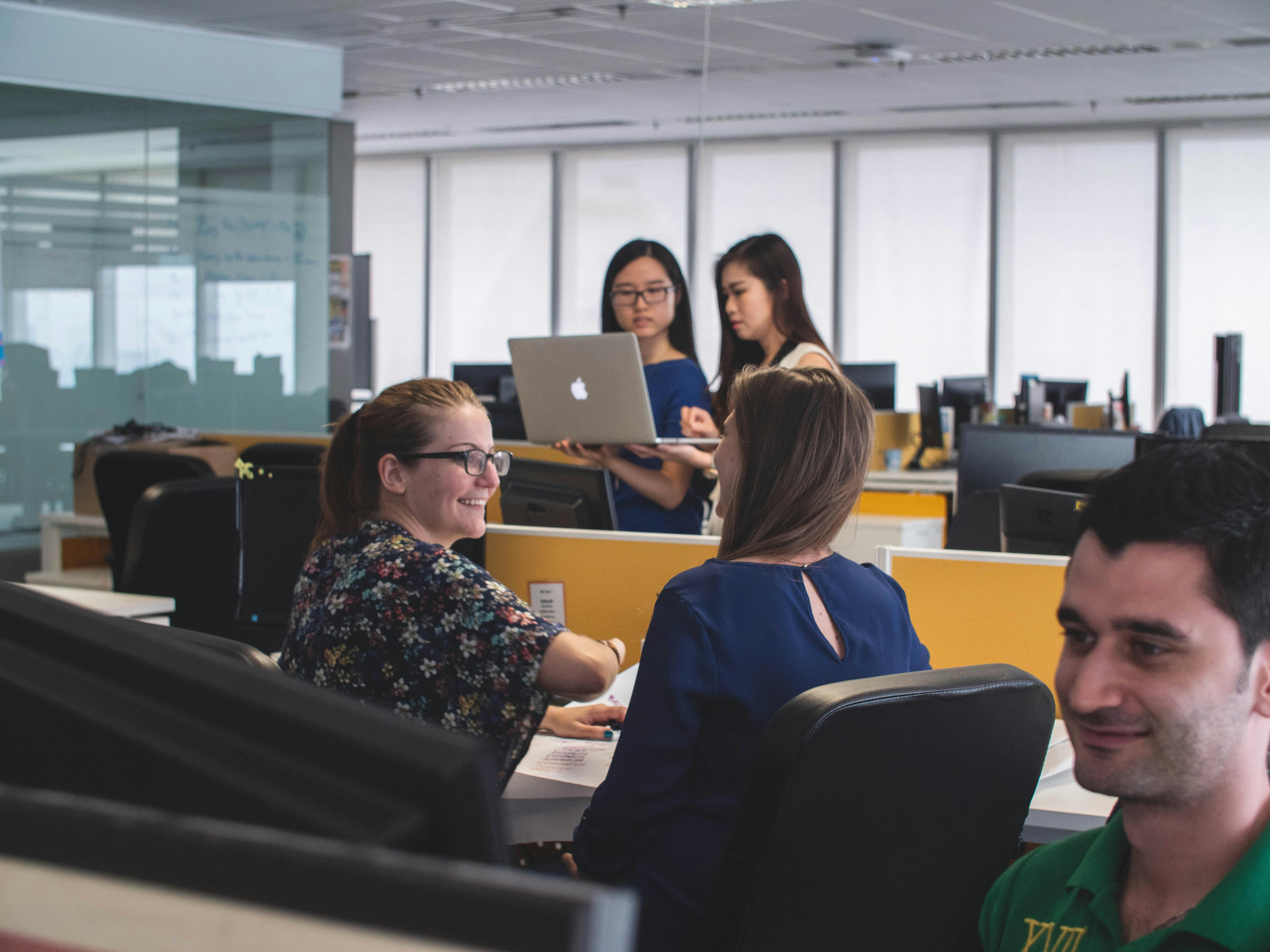 A few professionals working on computers in an office