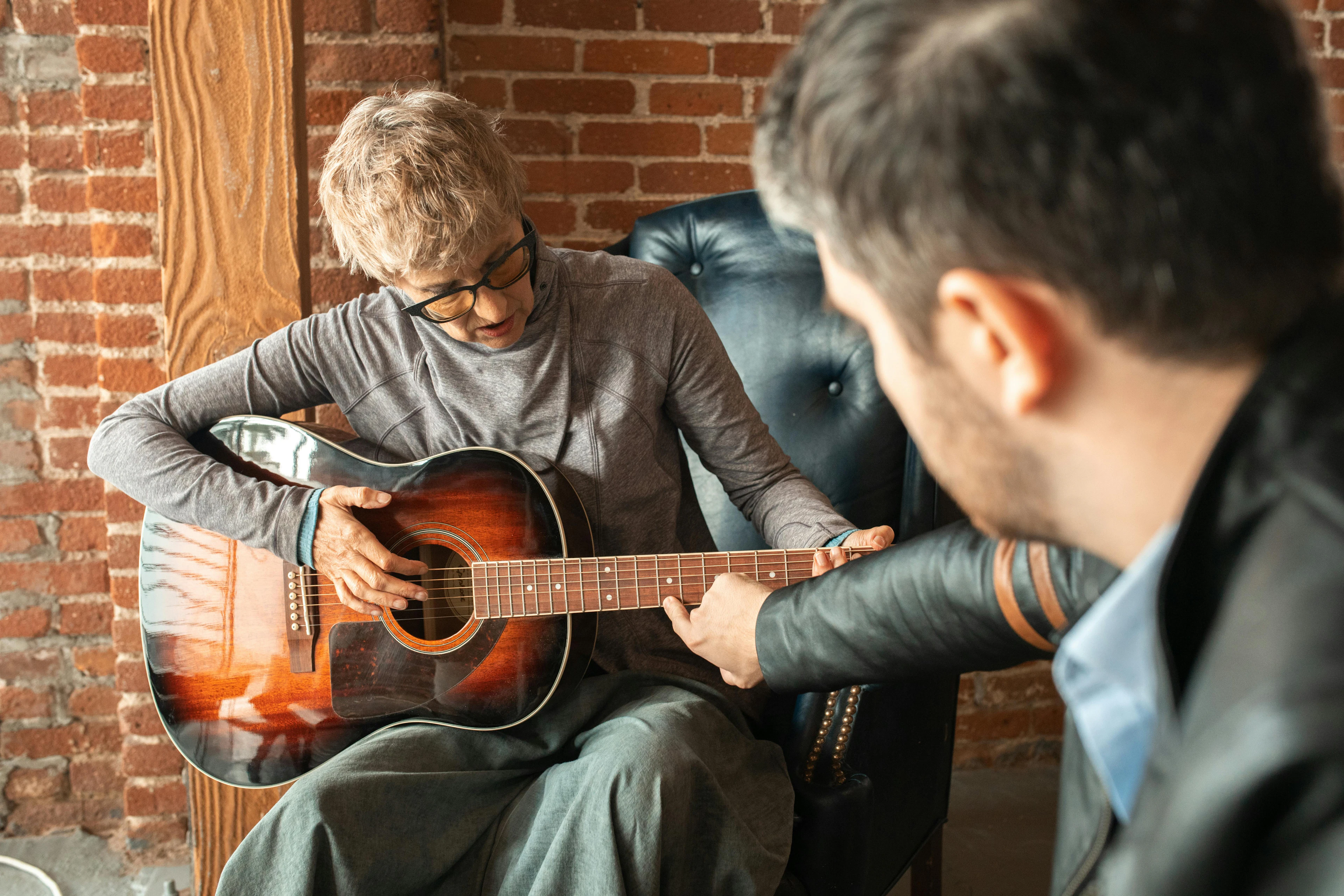 Adult guitar student receiving private music instruction
