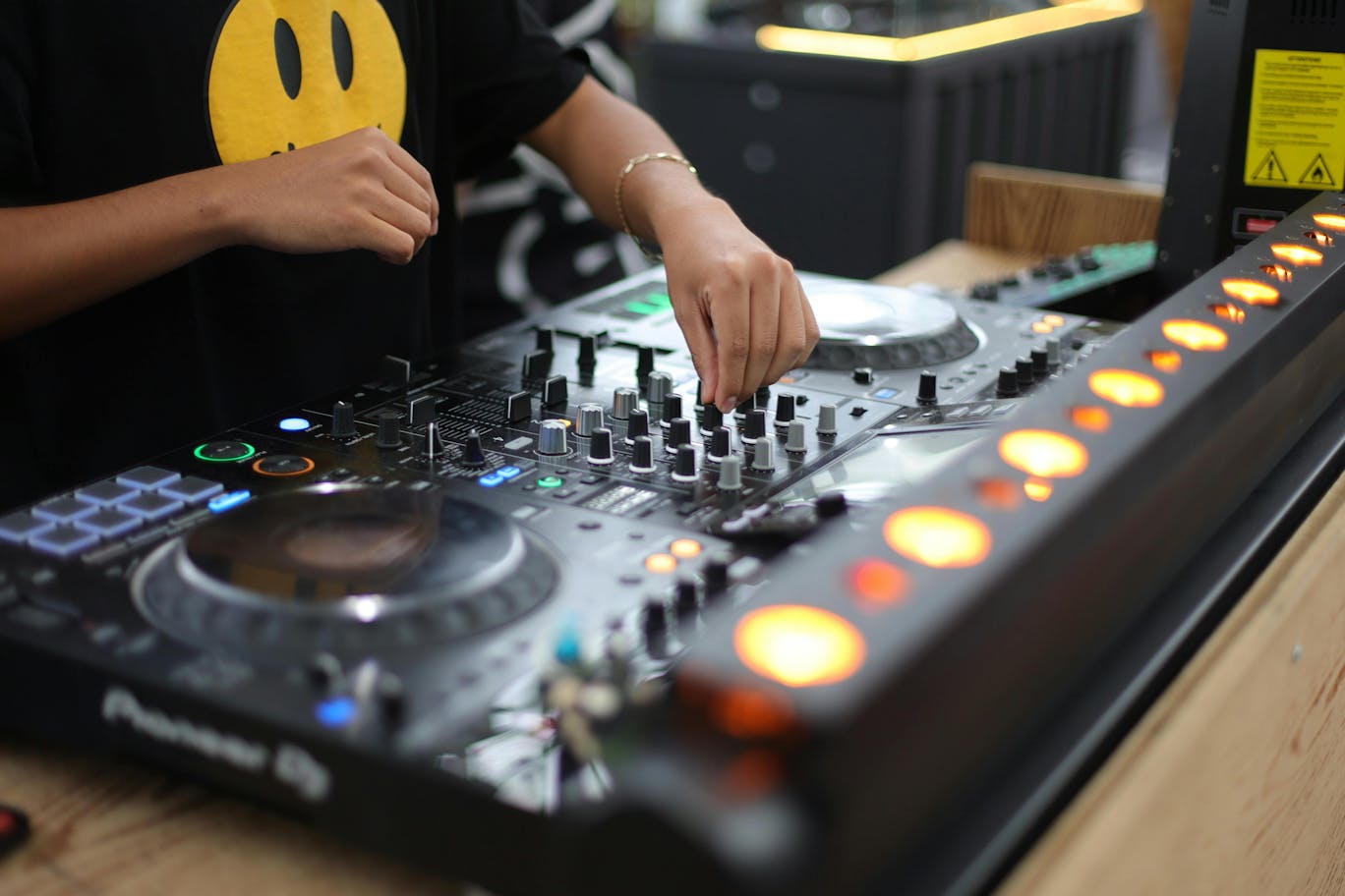 A student is practicing and turning one of the knobs of a DJ turntable