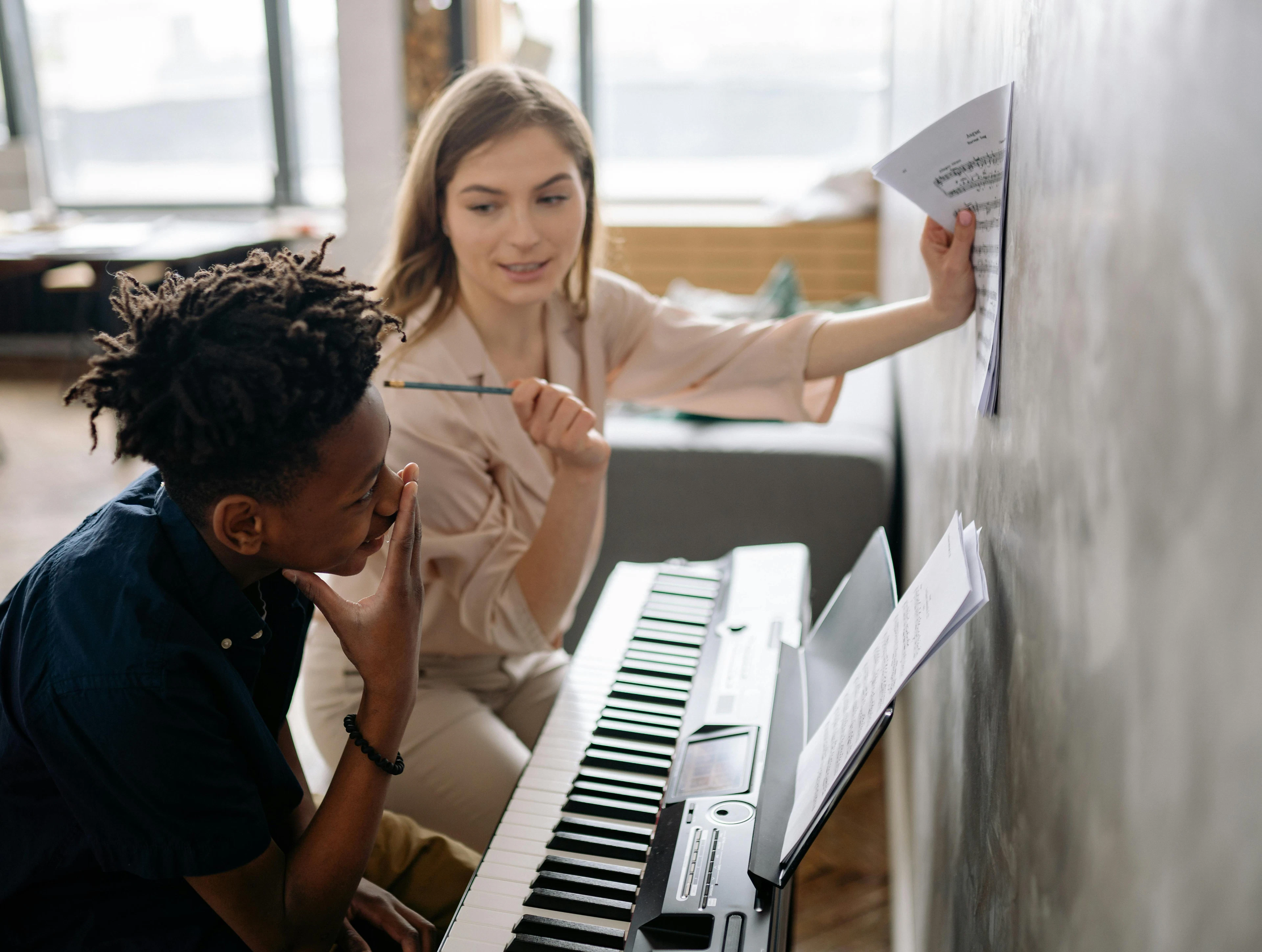 teacher with student learning songwriting and composition