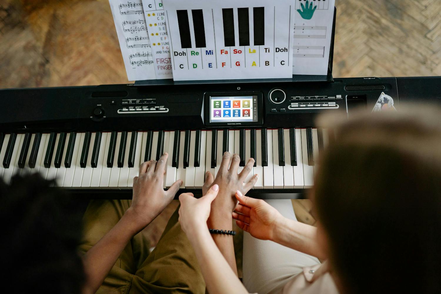 piano teacher and student learning together