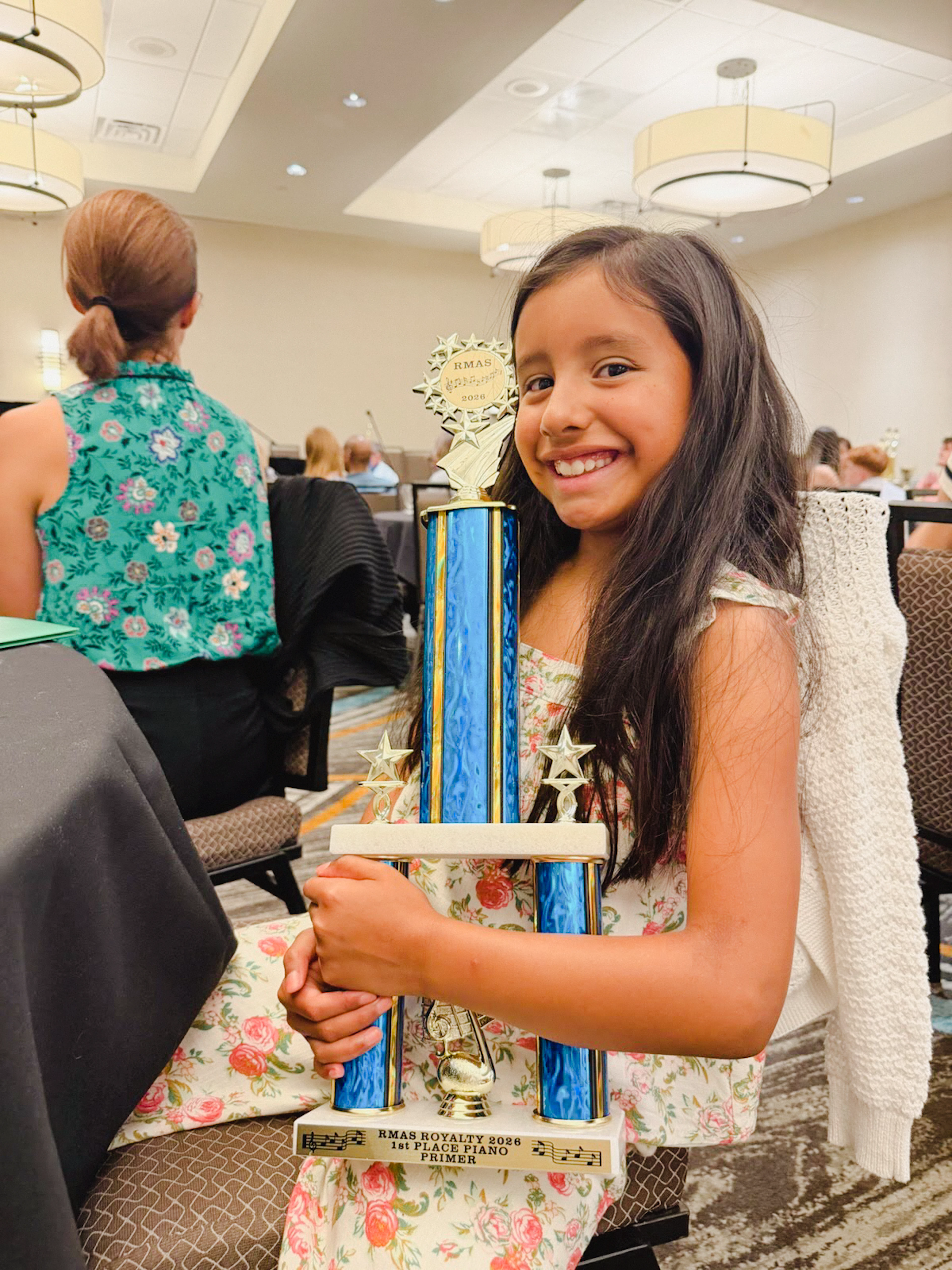 Moon Magnet Music Student Amelia with her first place trophy at  Rocky Mountain Accordion Society Piano Competition