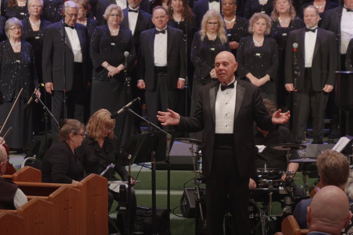 Director Allan Skoog speaking to the audience at a concert