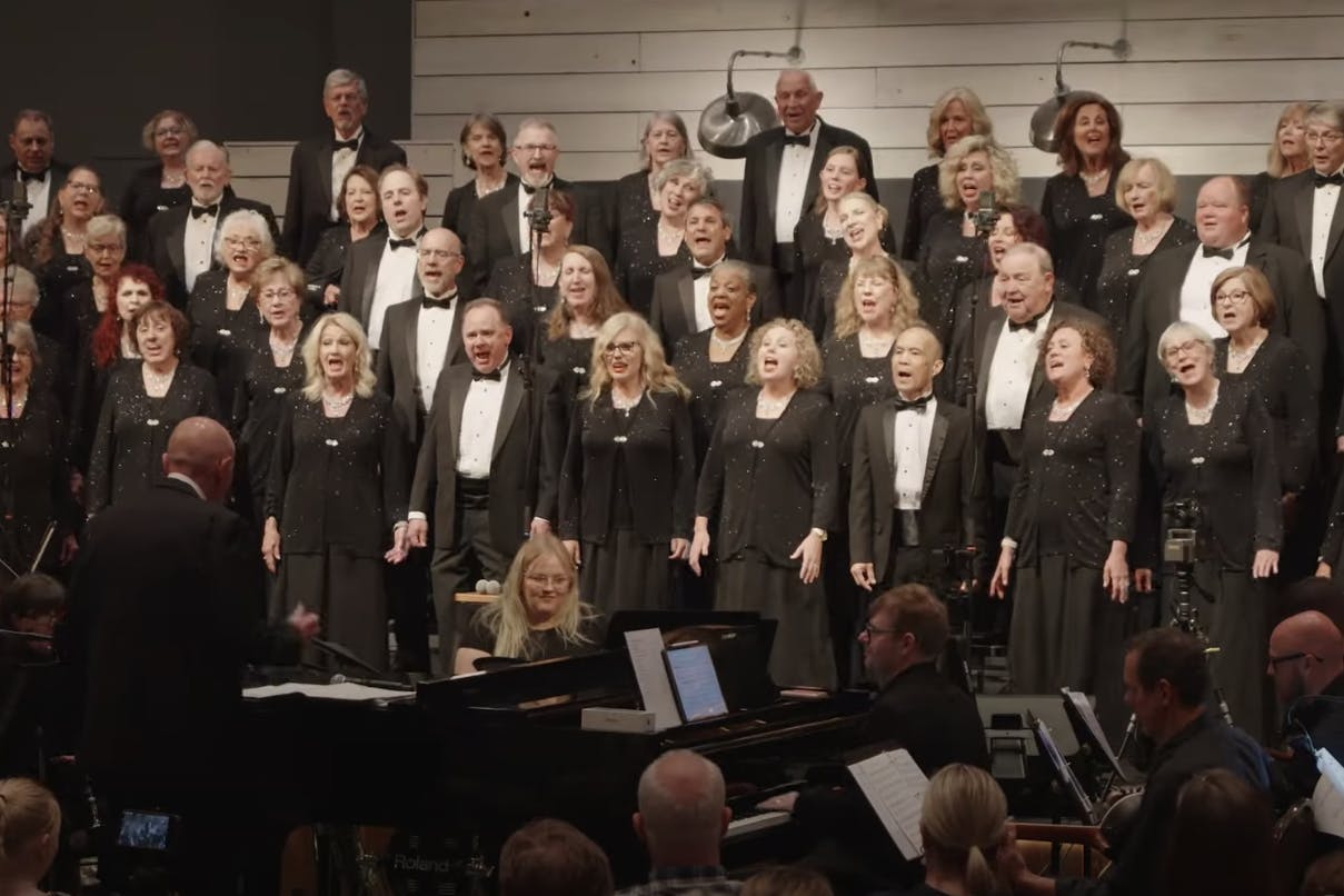 Mosaic choir and orchestra performing on stage