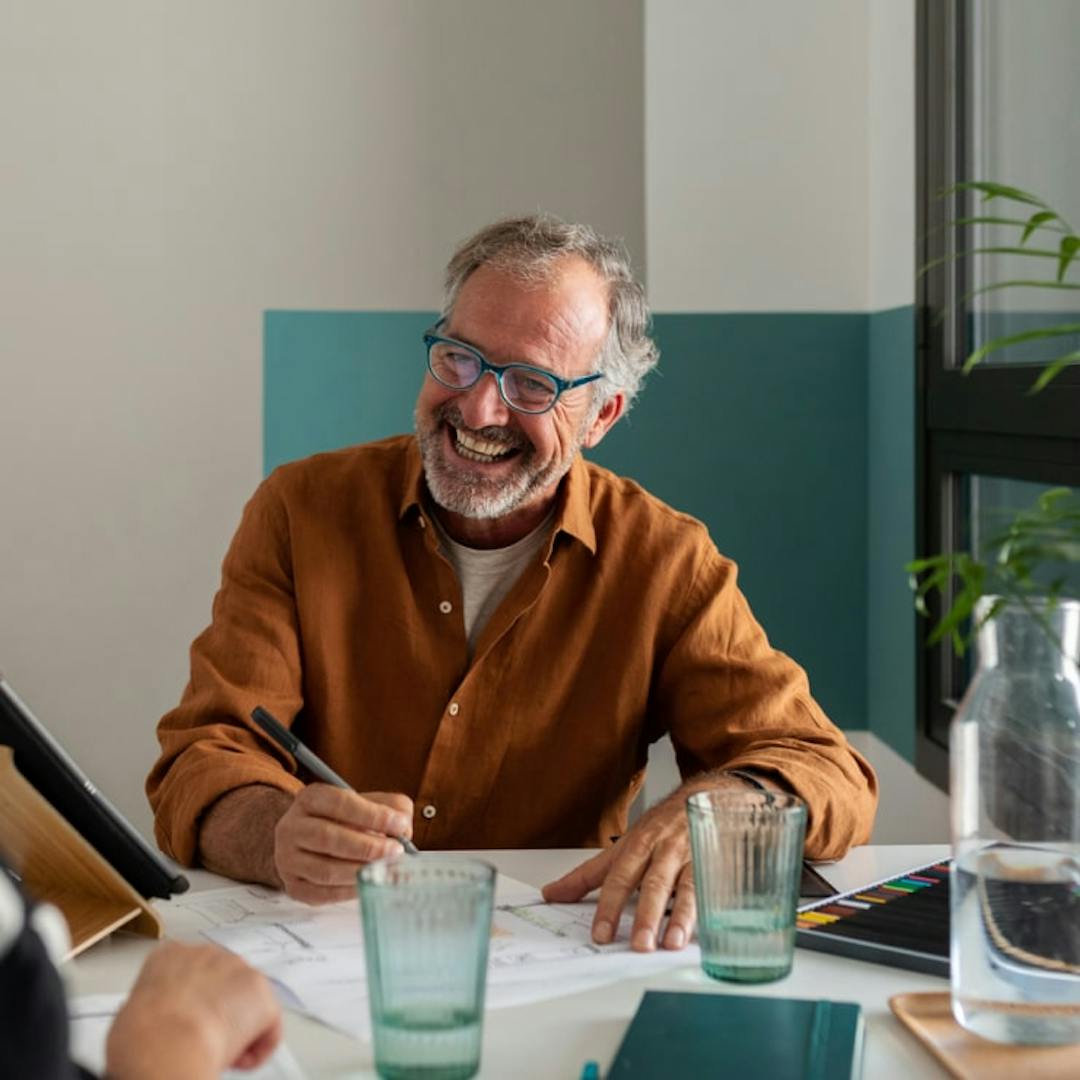 A person in an office setting smiling