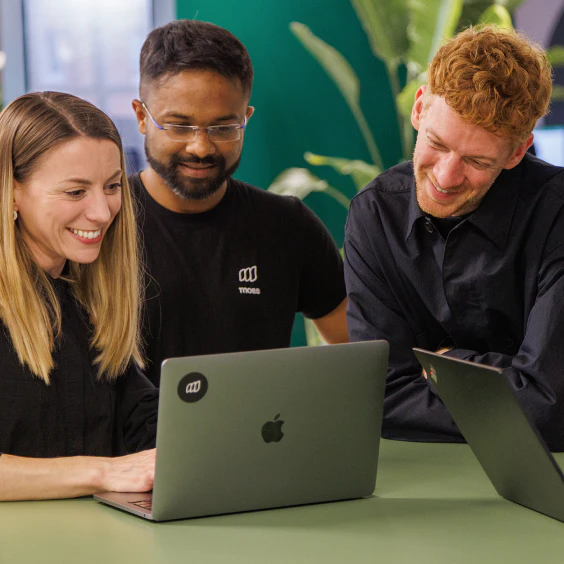 Coworkers collaborating on laptops