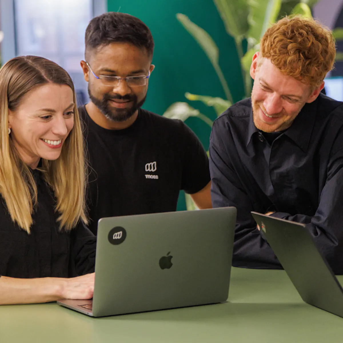 Coworkers collaborating on laptops