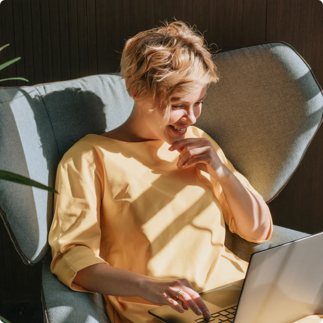 Footer human image on chair with laptop