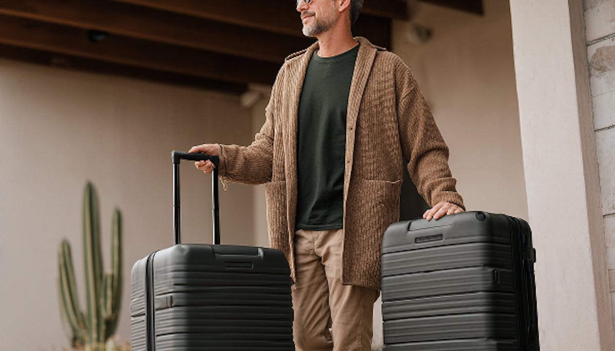 A man traveling with two bags