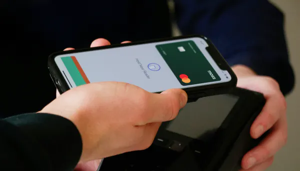 Someone paying with their phone using a virtual card
