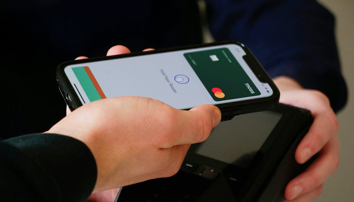 Someone paying with their phone using a virtual card