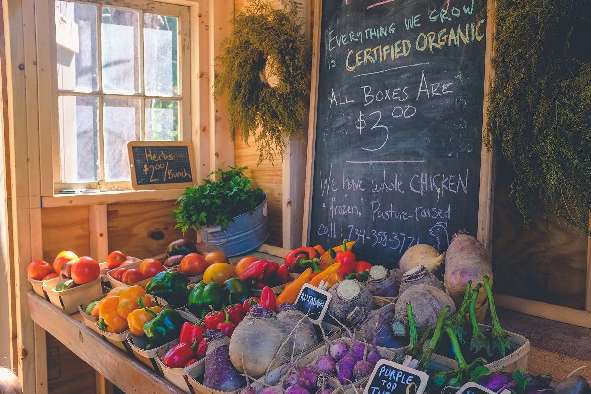 An organic food store advertising seasonal boxes of local vegetables. Eating the seasons means fresher produce, consumed closer to harvesting and with higher in nutritional value