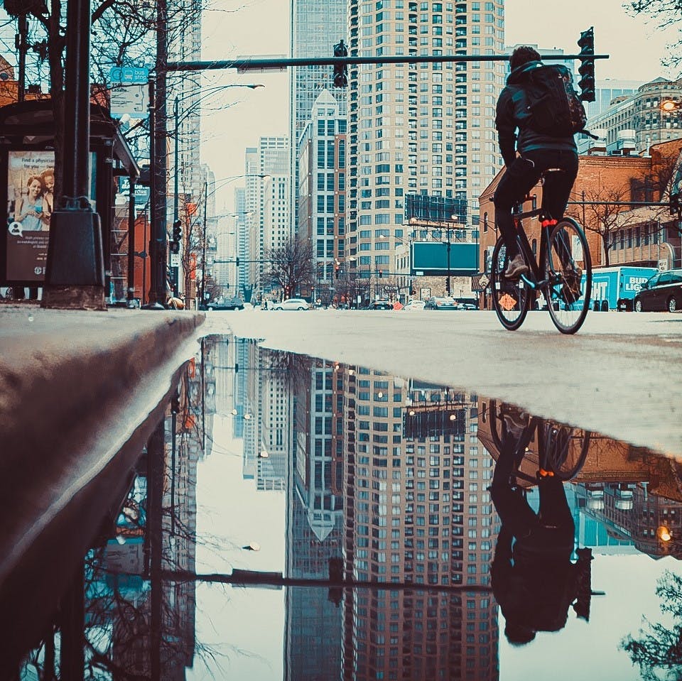 A person cycling to work through the city