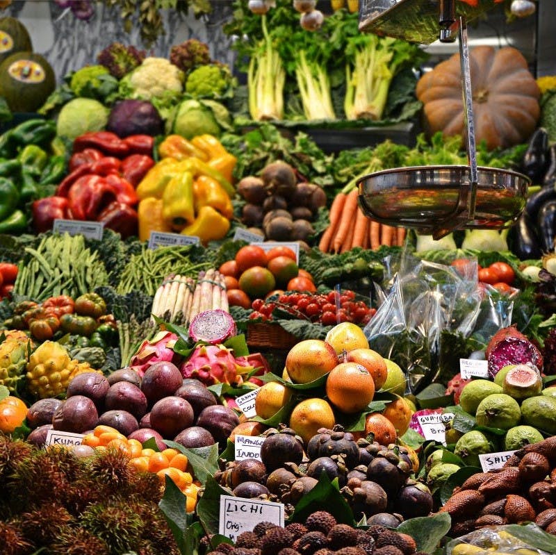 A variety of colorful vegetables displayed at a market stall.