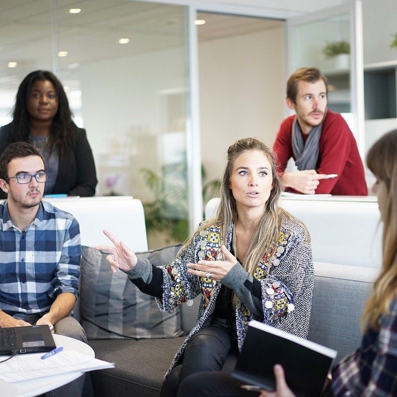 A green team working together in an office space.