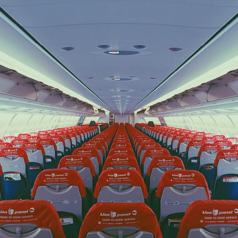 A photo showing the inside of a modern passenger airline plane. The more seats on a flight, the more sustainable the flying. 