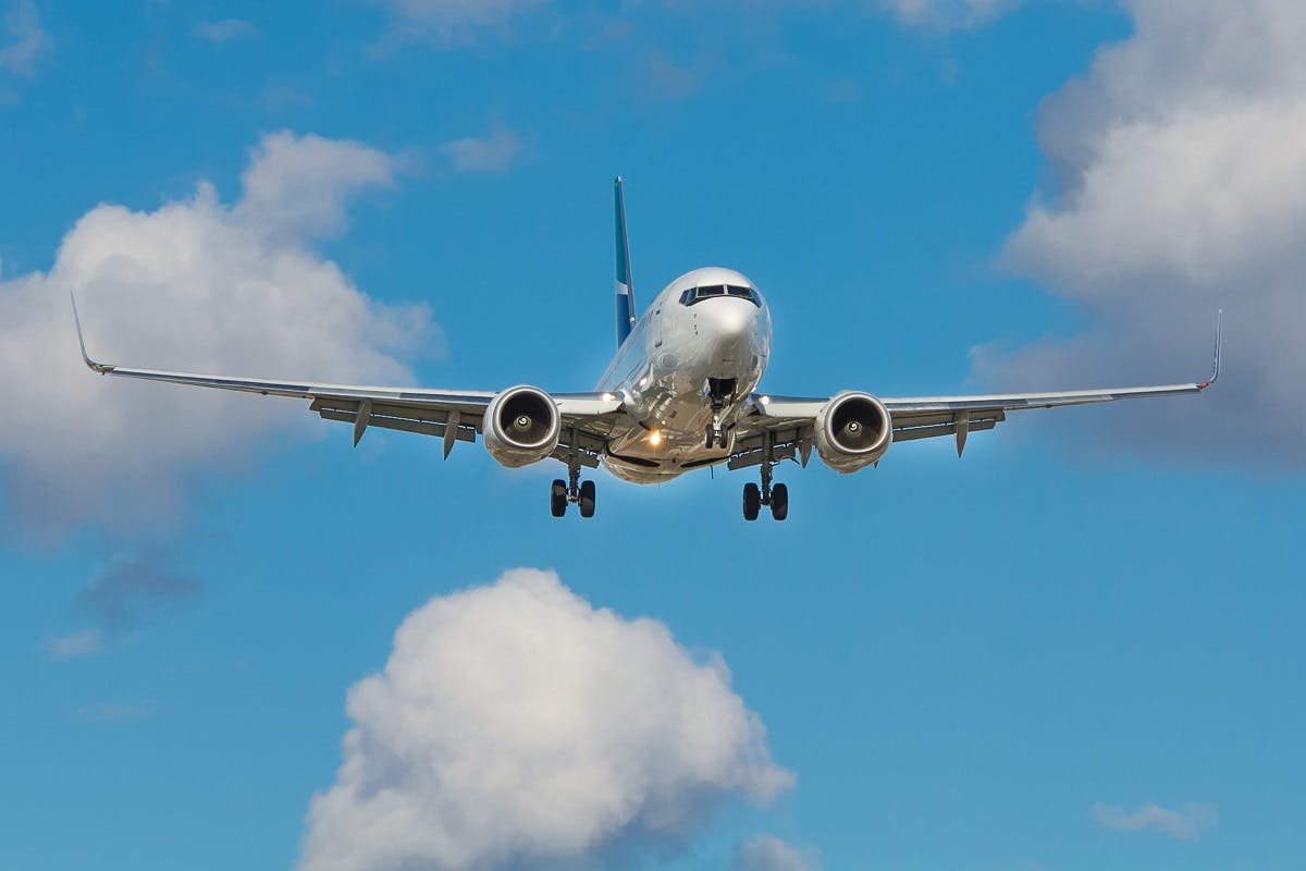 A plane landing. Flying is one of the largest contributors to CO2 emissions. As such many airlines are adopting carbon offsetting programmes.