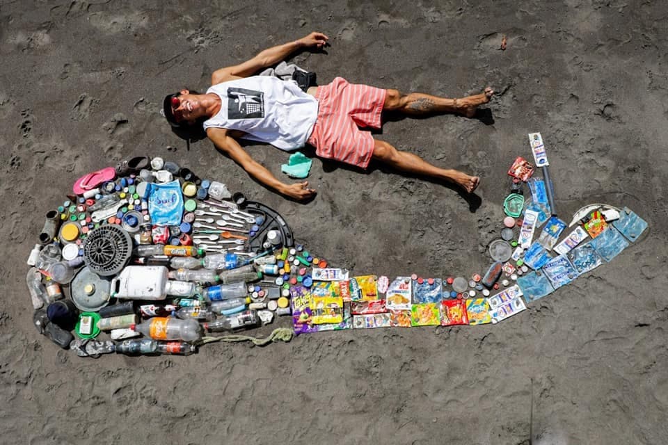Mutsu Riva laying next to all the plastic he has beach cleaned in El Salvador